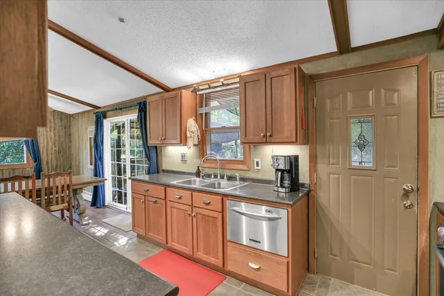 a kitchen with stainless steel appliances granite countertop a stove a sink dishwasher and a refrigerator