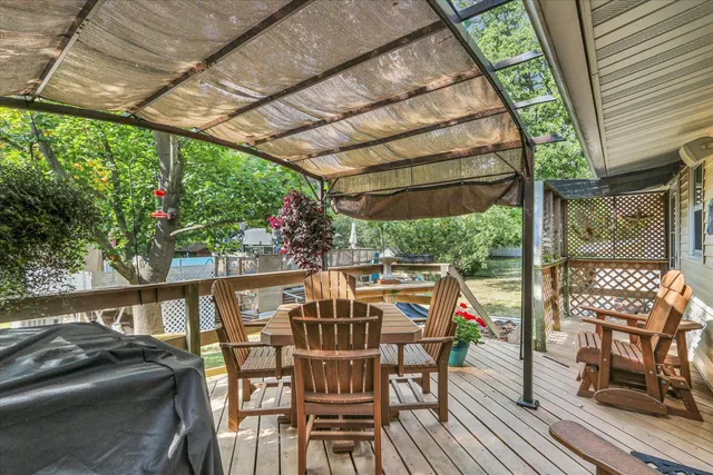 a backyard of a house with table and chairs