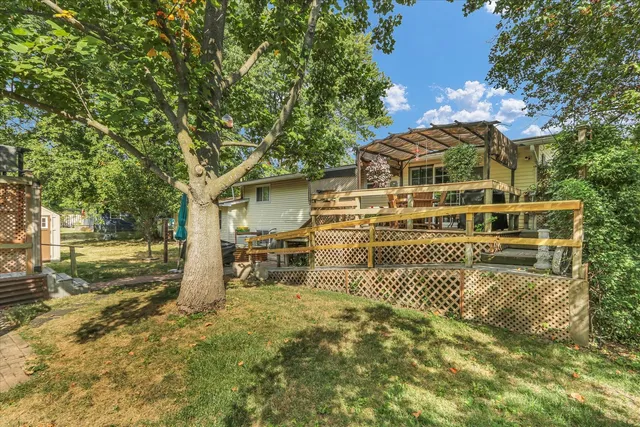 a view of a house with yard and sitting area