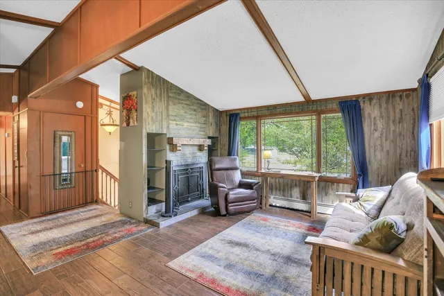 a bedroom with furniture and large windows