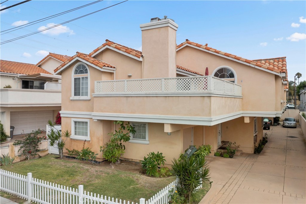 2517 Rockefeller Lane, Unit B Redondo Beach, CA 90278 - Photo 1 of 36 a view of a white house with large windows and a small yard