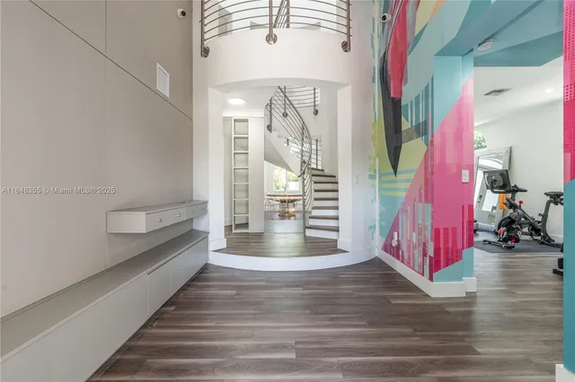 a view of entryway and hall with wooden floor