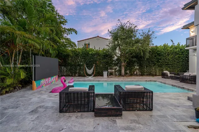 a view of a backyard with sitting area