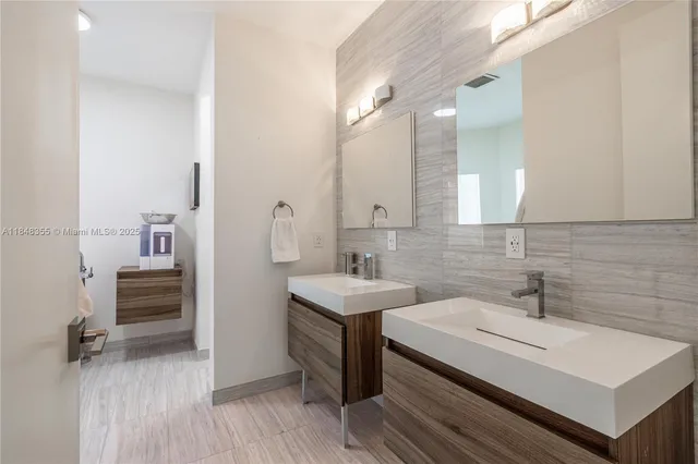 a bathroom with a sink a toilet and mirror