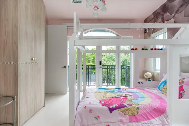 a bedroom with a bed and a large window