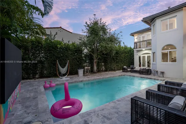 a backyard of a house with seating space and trees