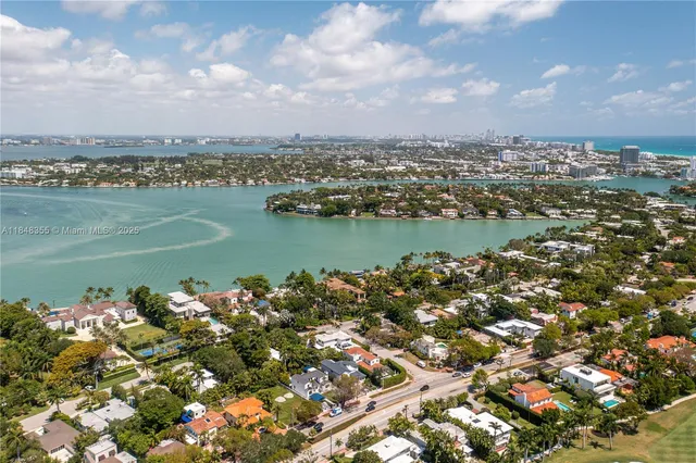 an aerial view of a city with lake view in back