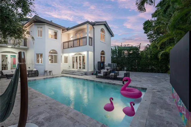 a view of a swimming pool with outdoor seating