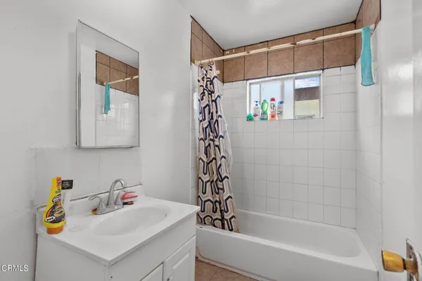 a bathroom with a bathtub a sink and a shower
