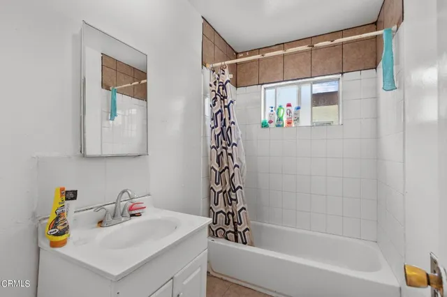 a bathroom with a bathtub a sink and a shower