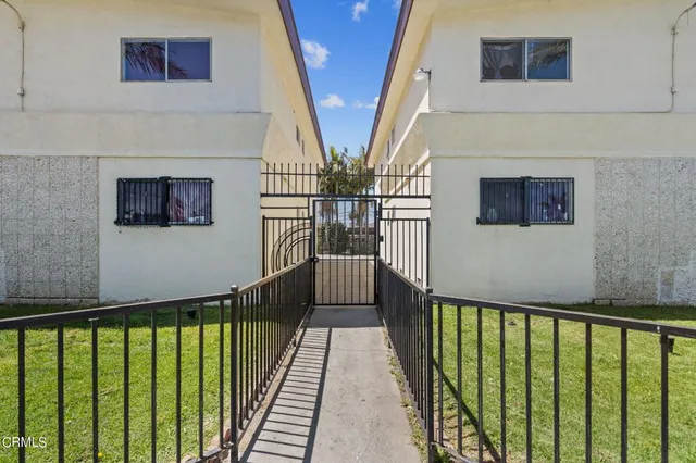 a view of a hallway with wooden floor and stairs