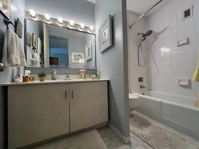 a bathroom with a double vanity sink a mirror a bathtub and shower
