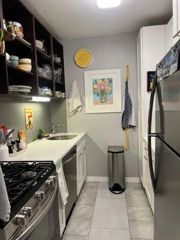 a kitchen with stainless steel appliances granite countertop a stove and a refrigerator