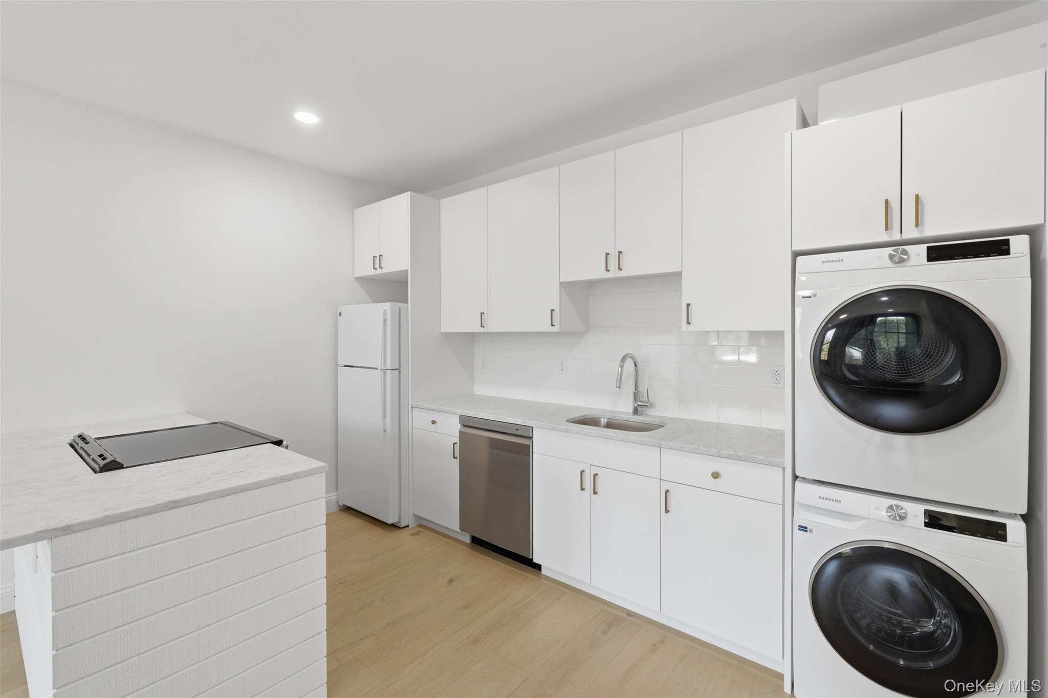 207 Main Street, Unit 3 Beacon, NY 12508 - Photo 13 of 23 a utility room with sink dryer and washer