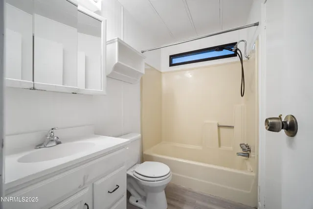 a view of a patio with table and chairs under an umbrella