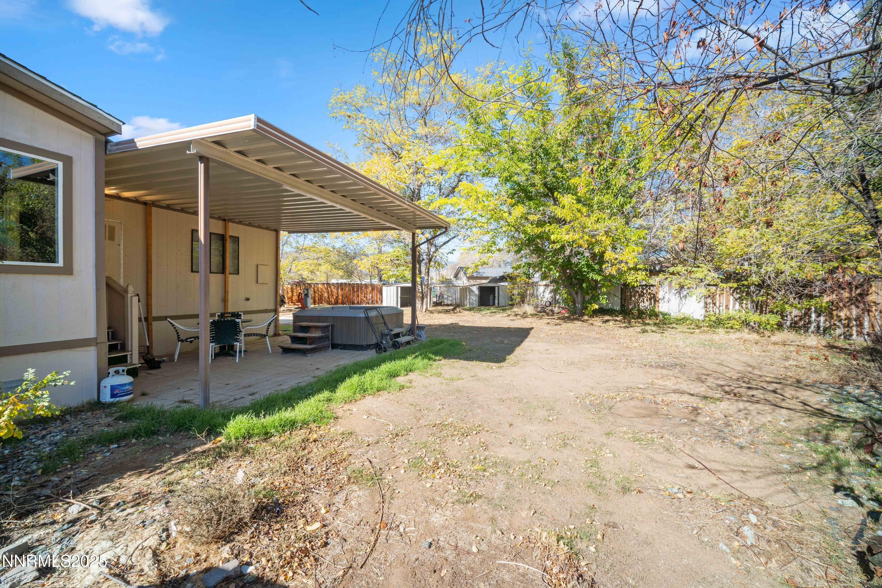 2524 Sneddon Way Carson City, NV 89706 - Photo 24 of 34 a view of a patio with table and chairs under an umbrella