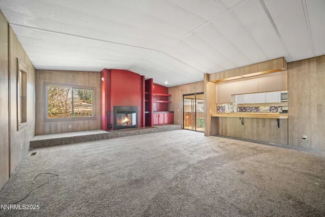 a big room with windows and a fireplace