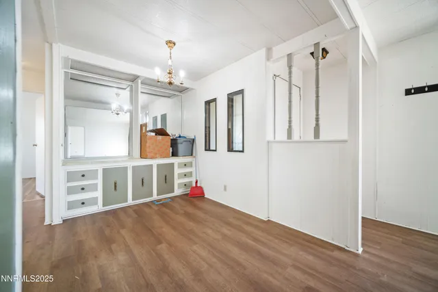 a view of a kitchen with wooden floor and electronic appliances