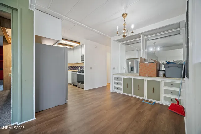 a kitchen with cabinets oven and a window