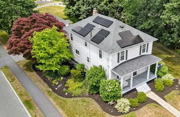 an aerial view of a house with a yard