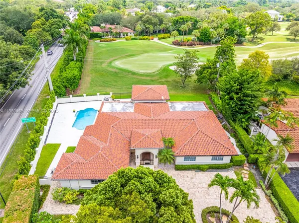 a aerial view of a house with outdoor space pool seating area and yard