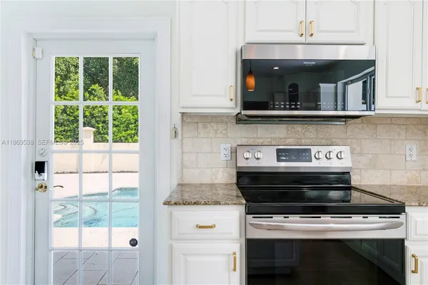 a stove top oven sitting inside of a kitchen