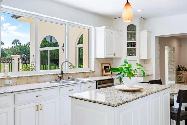 a kitchen with sink and cabinets