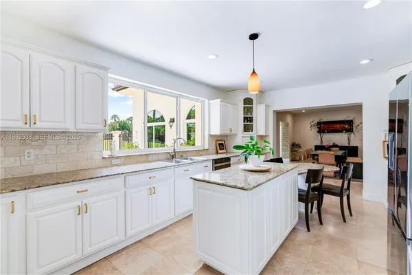 a kitchen with granite countertop a sink and a window