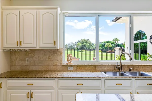 a kitchen with a sink and a large window