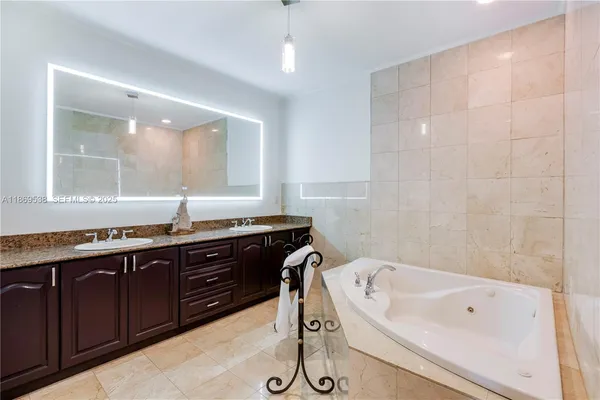 a bathroom with a granite countertop sink a toilet and shower