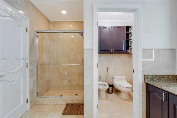 a bathroom with a sink a toilet and a shower