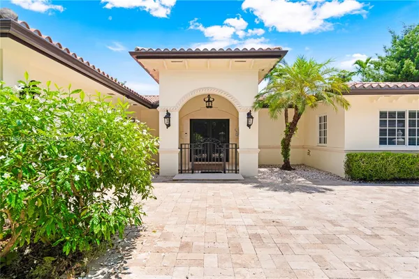 a front view of a house with a garden