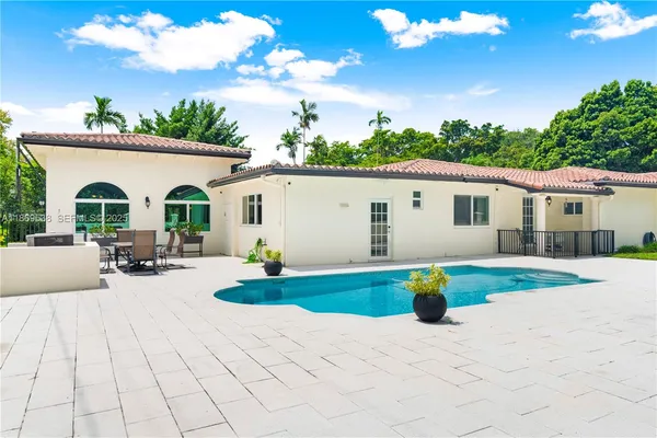 a view of a house with a backyard and a garden
