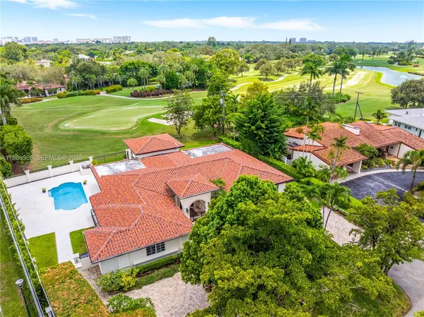a view of a swimming pool with a lot of trees in the background