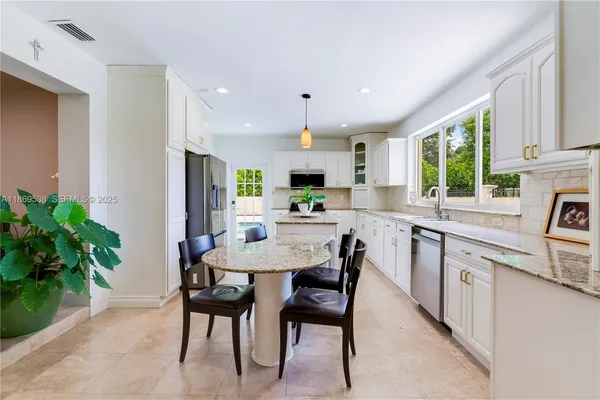 a kitchen with a table and chairs in it