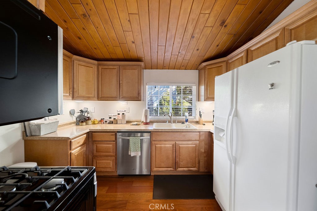 33353 Music Camp Road Running Springs, CA 92382 - Photo 13 of 30 a kitchen with stainless steel appliances a stove a refrigerator and a sink