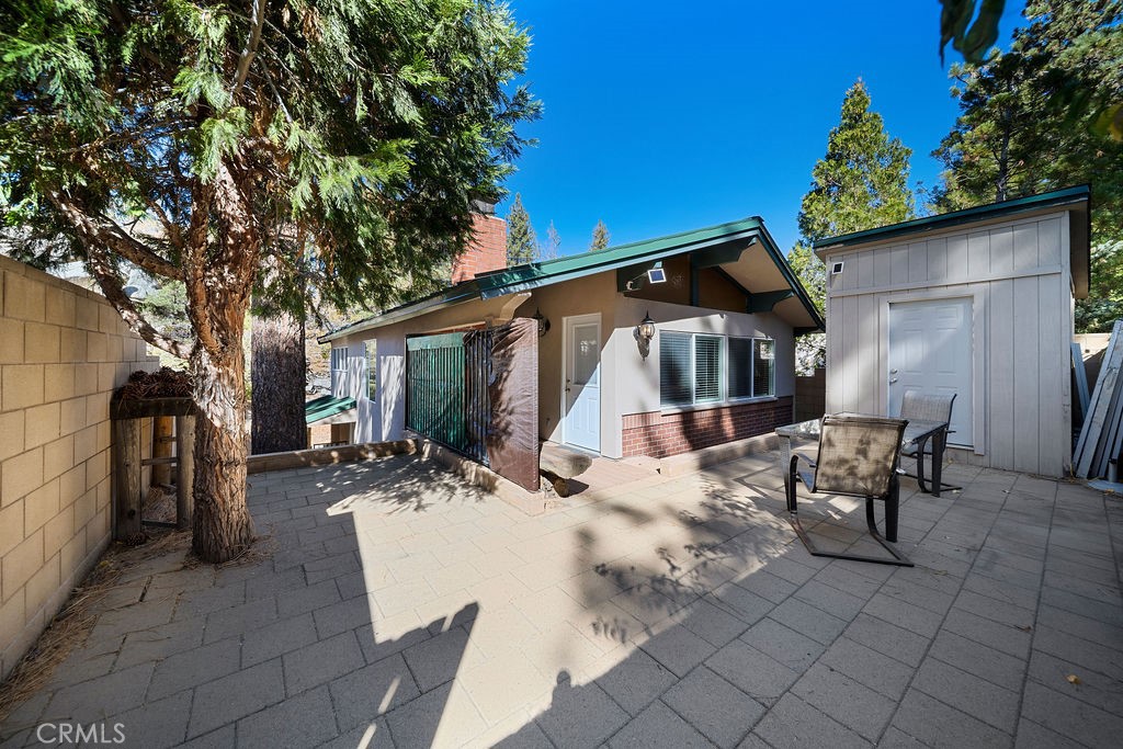 33353 Music Camp Road Running Springs, CA 92382 - Photo 18 of 30 a view of a patio with table and chairs with wooden fence and plants