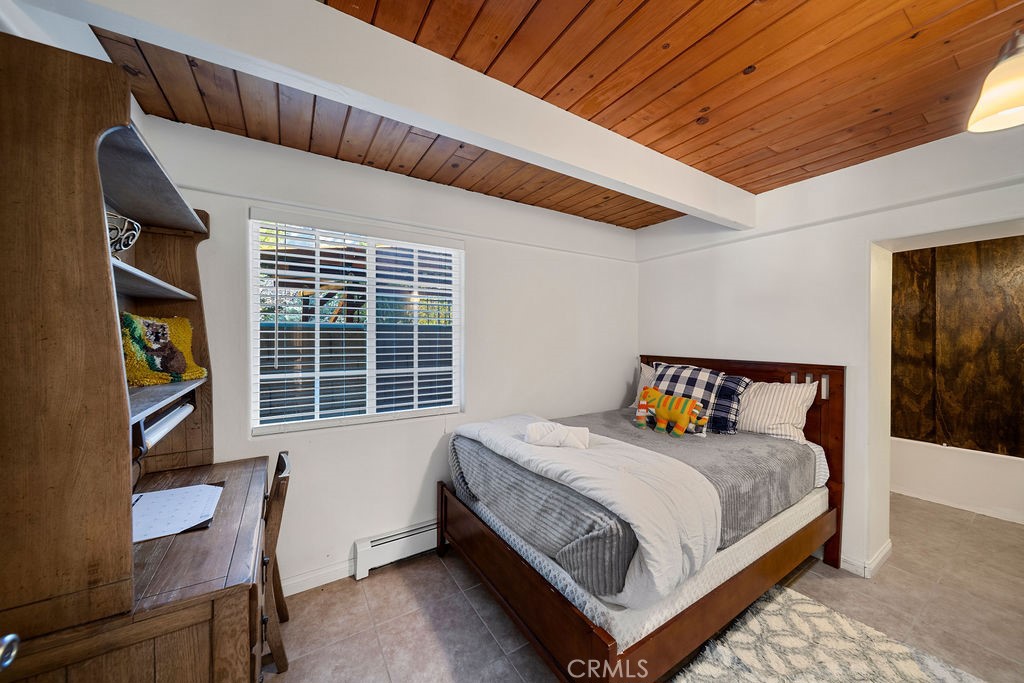 33353 Music Camp Road Running Springs, CA 92382 - Photo 4 of 30 a bed sitting in a bedroom next to a window