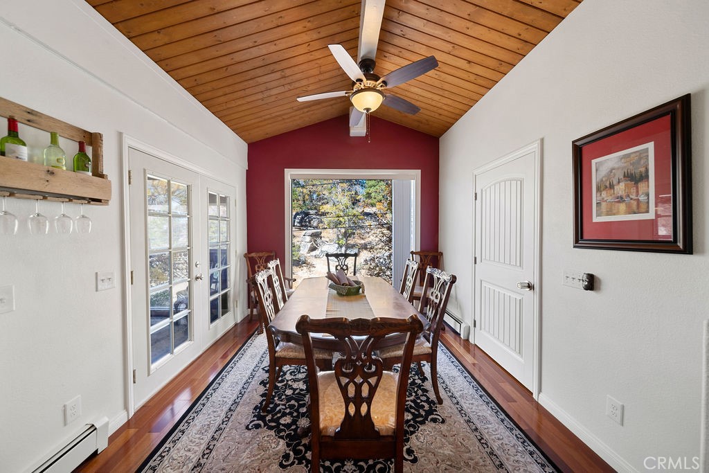 33353 Music Camp Road Running Springs, CA 92382 - Photo 5 of 30 a view of a dining room with furniture wooden floor and a chandelier