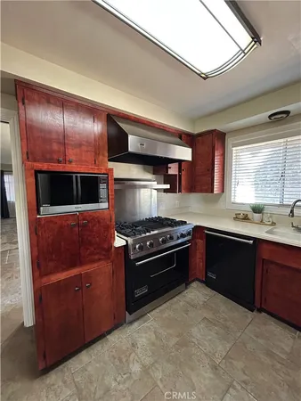 a kitchen with stainless steel appliances granite countertop a stove and a refrigerator