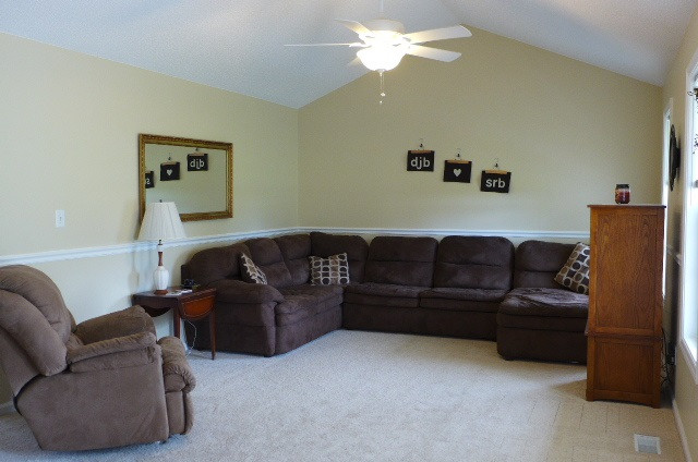 Neutral paint colors, large, vaulted ceilings and chair rail. Living Room