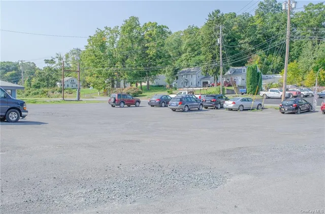 a view of a street with a couple of cars parked in front of it