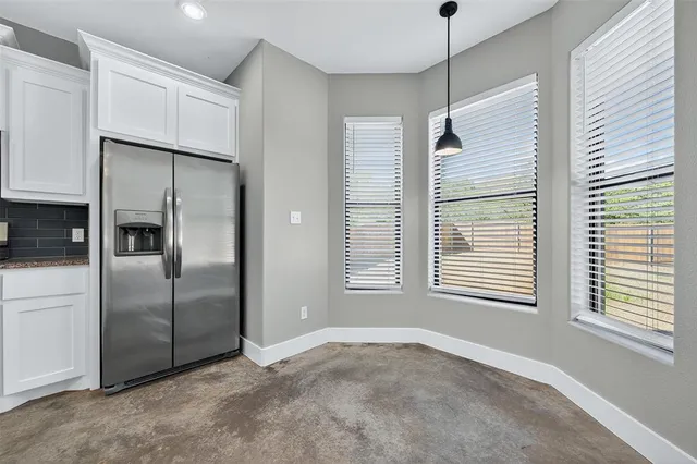 a view of a kitchen with a closet and windows