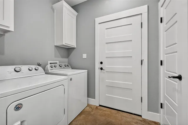 a view of storage and utility room with washer and dryer
