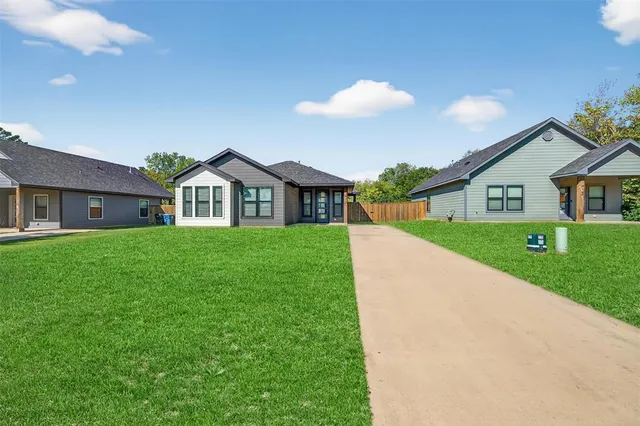 a front view of house with yard and green space