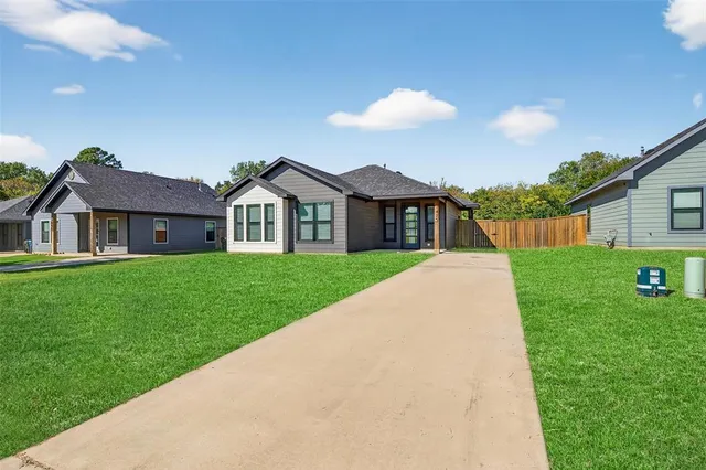 a view of house that has a yard