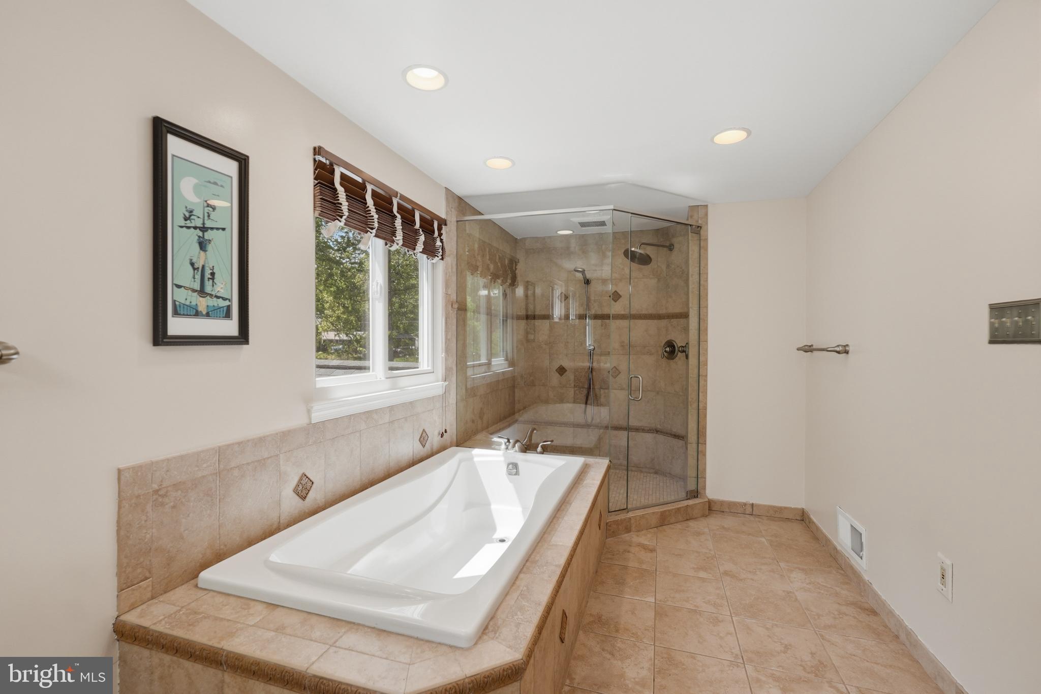 7006 Barnack Drive Springfield, VA 22152 - Photo 32 of 56 a bathroom with a tub a sink and glass door