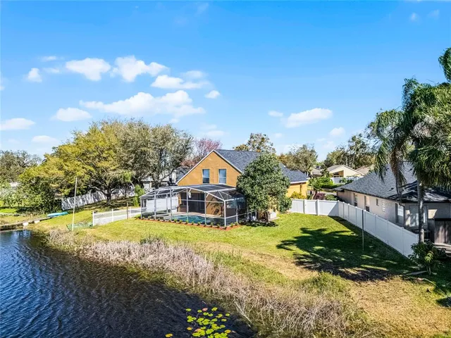 a view of a house with swimming pool and sitting area