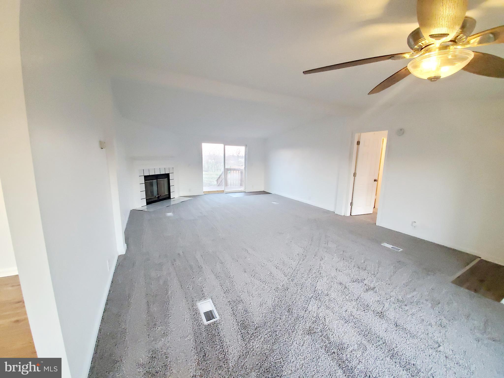 202 Muzzey Road Shepherdstown, WV 25443 - Photo 4 of 19 Living Room w/new carpet & FP and access to deck