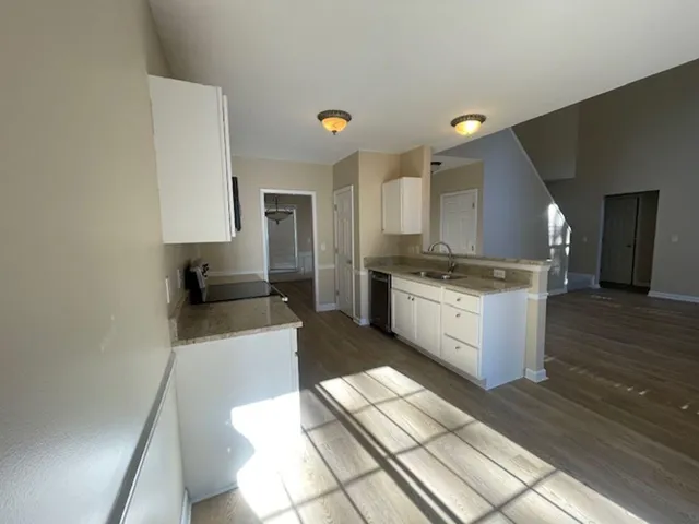 a large kitchen with a stove a sink dishwasher and a refrigerator